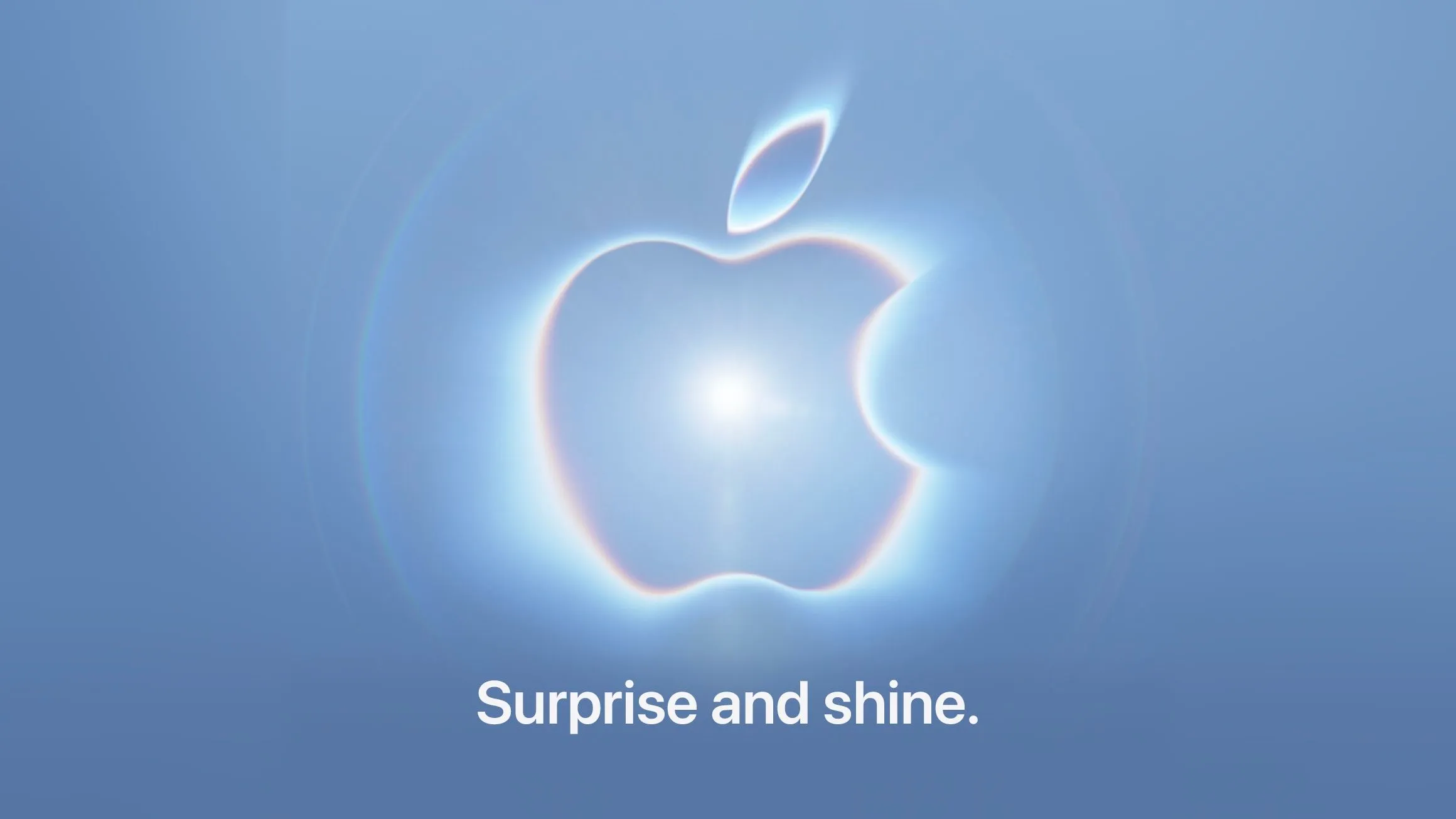 L'invito dell'evento Apple del 9 settembre: il logo Apple luminoso su fondo blu, con la scritta «Surprise and shine.»