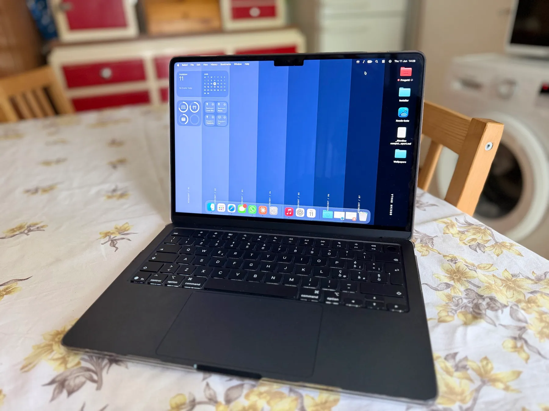 MacBook Air M5 Midnight with Colorways wallpaper on screen