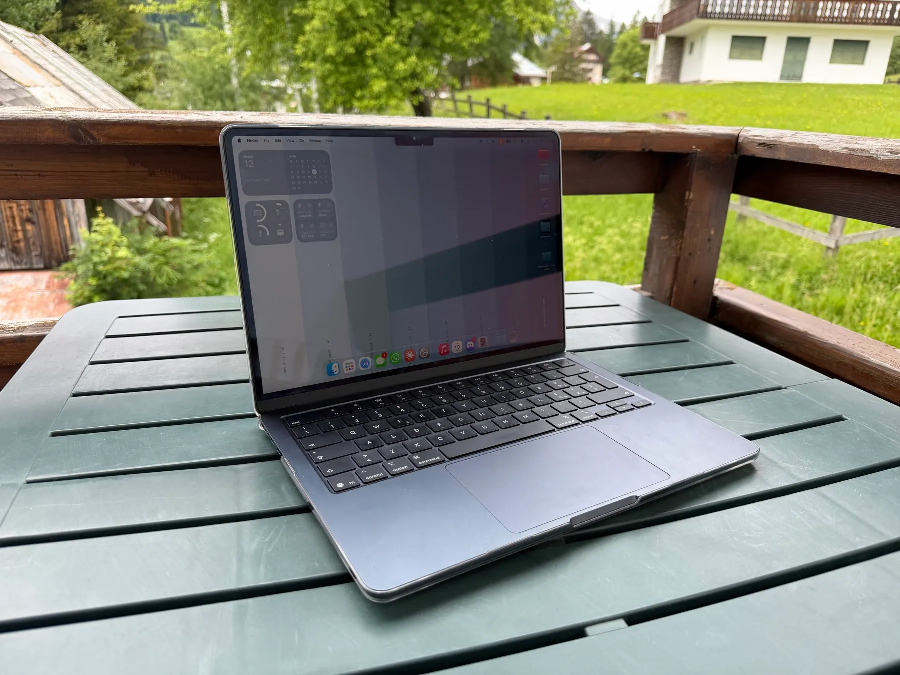 MacBook Air M5 Midnight on an outdoor terrace table
